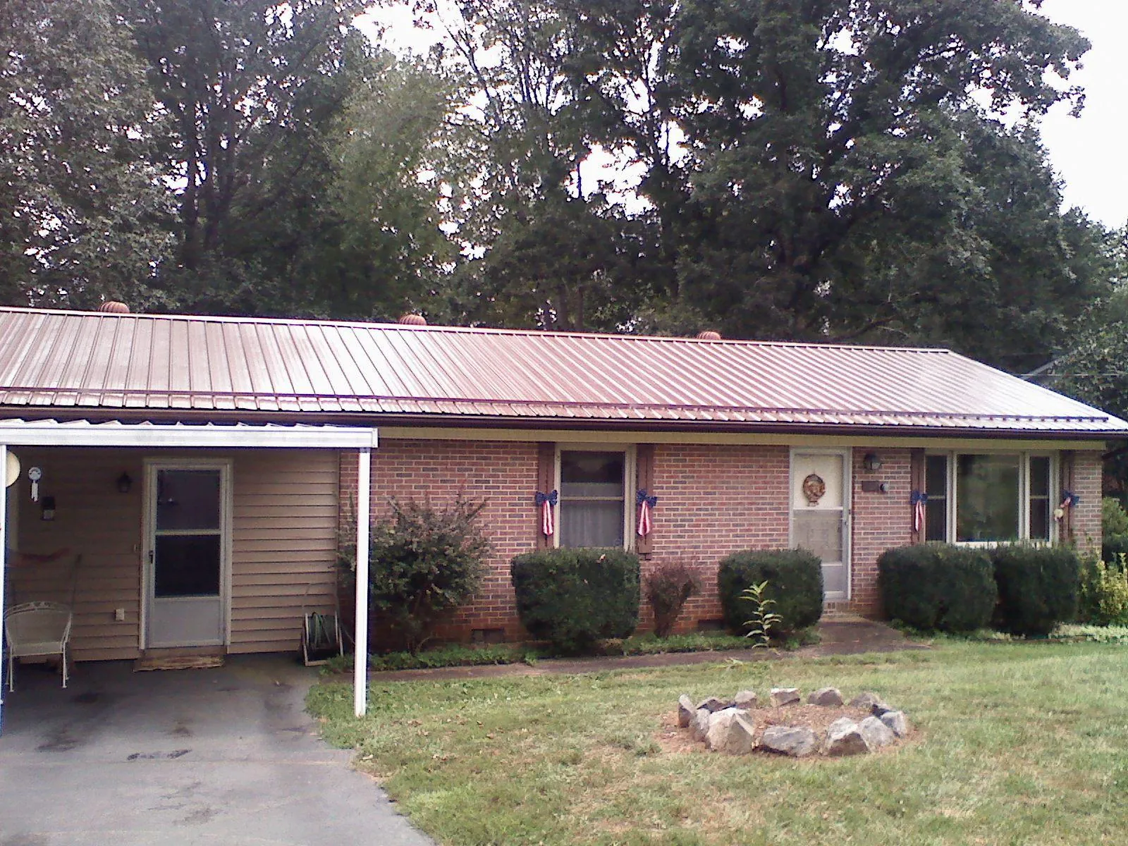 Bronze metal roof and carport on a brick ranch home — Roof Repair work by our crew in Centerbrook